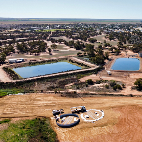 Aerial view of 2 open water storage dams in foreground, Mukinbudin township in background