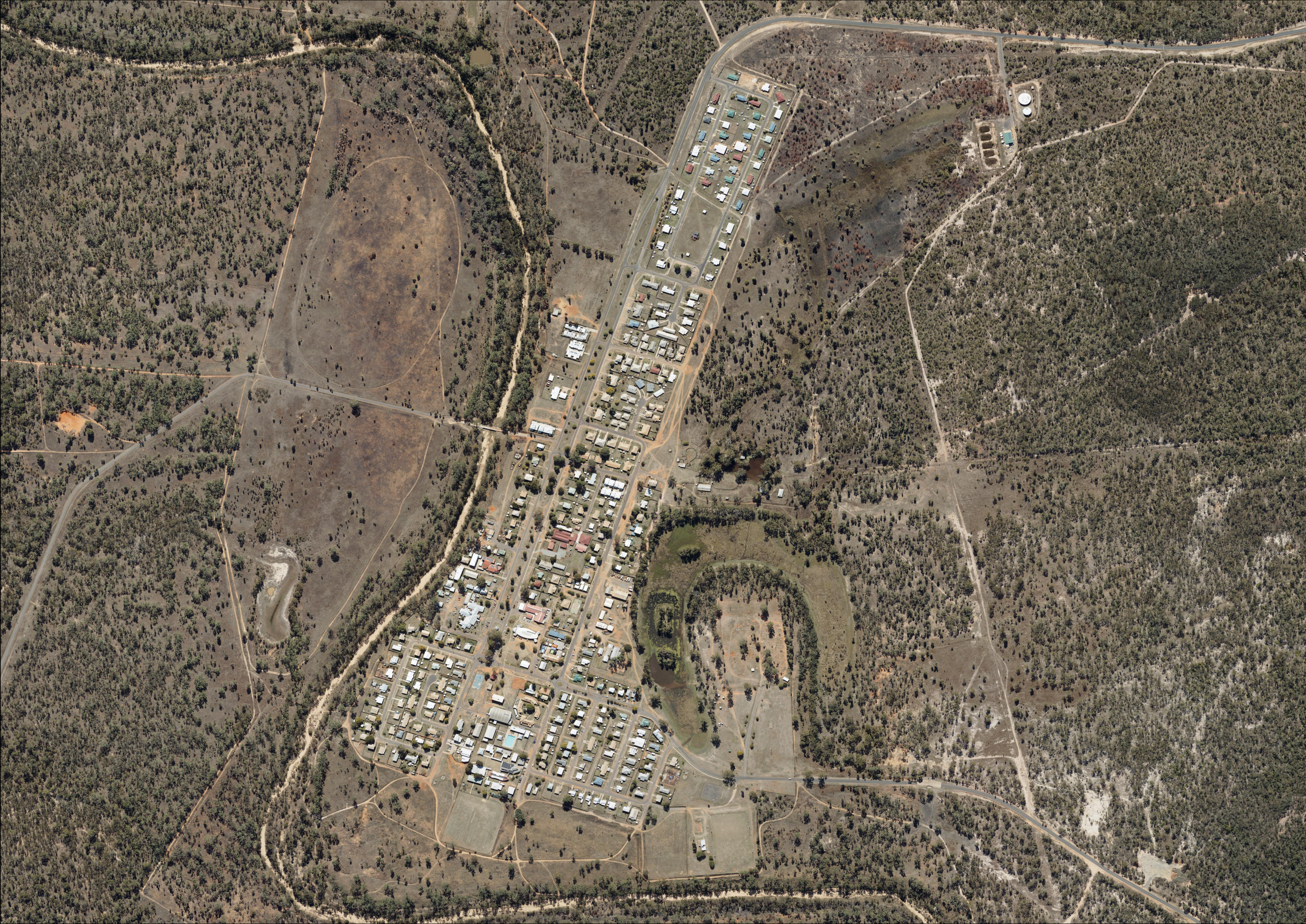 An aerial view of Woorabinda showing buildings, roads and surrounding vegetation.