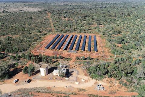 An aerial view of the pump station in Hermidale, showing the supporting infrastructure and nearby solar panels and arid bushland.