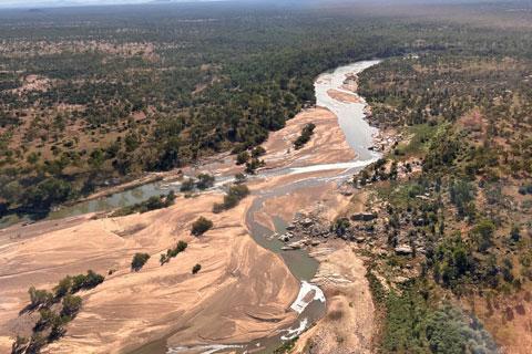 The Burdekin River flowing with bushland on either side.