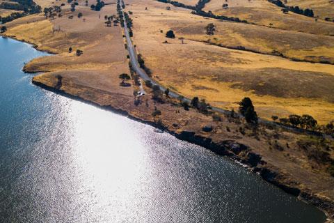 Aerial view over the Upper Coliban Reservoir dam wall, including inlet tower of Coliban dam.