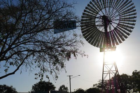 Silhouetted tree and Windmill at sunset near Hughenden Queensland