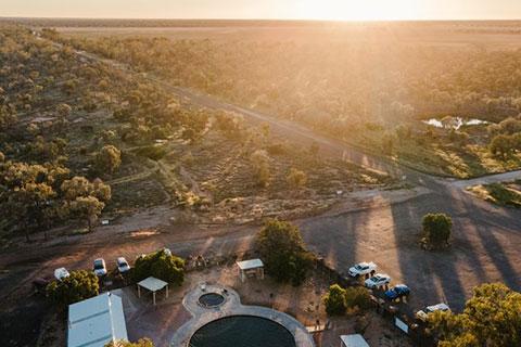 Aerial view of the Lightning Ridge landscape with a bore bath in the foreground.
