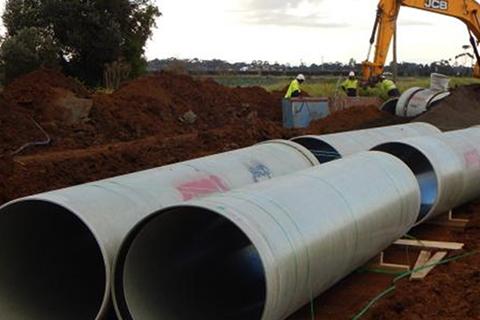 Pipes, workers and crane.