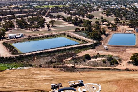 Aerial view of 2 open water storage dams in foreground, Mukinbudin township in background