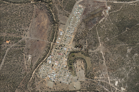 An aerial view of Woorabinda showing buildings, roads and surrounding vegetation.
